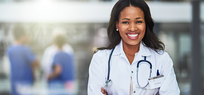 a smiling doctor crosses her arms