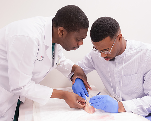 two male doctors practice surgery