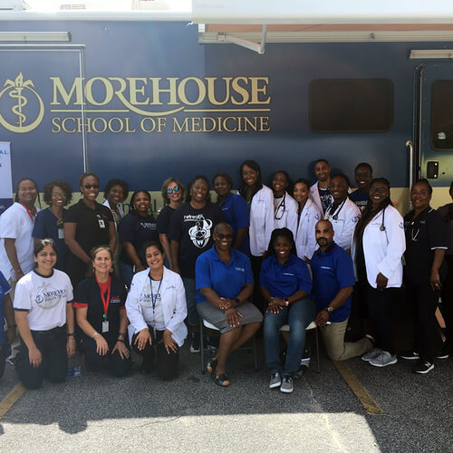 the HEAL clinic team stands in front of their mobile